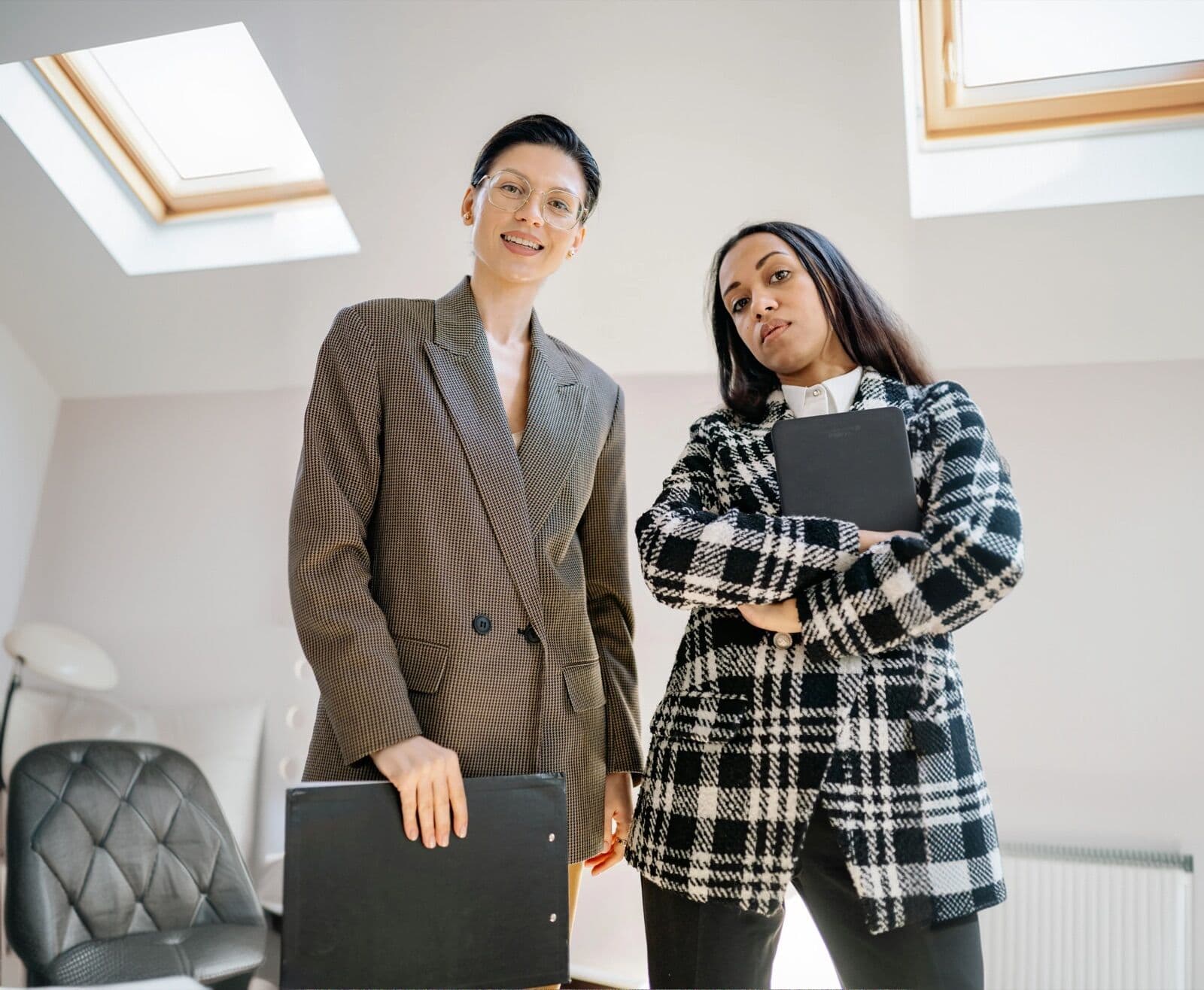 Two professional experts standing together in a modern workspace